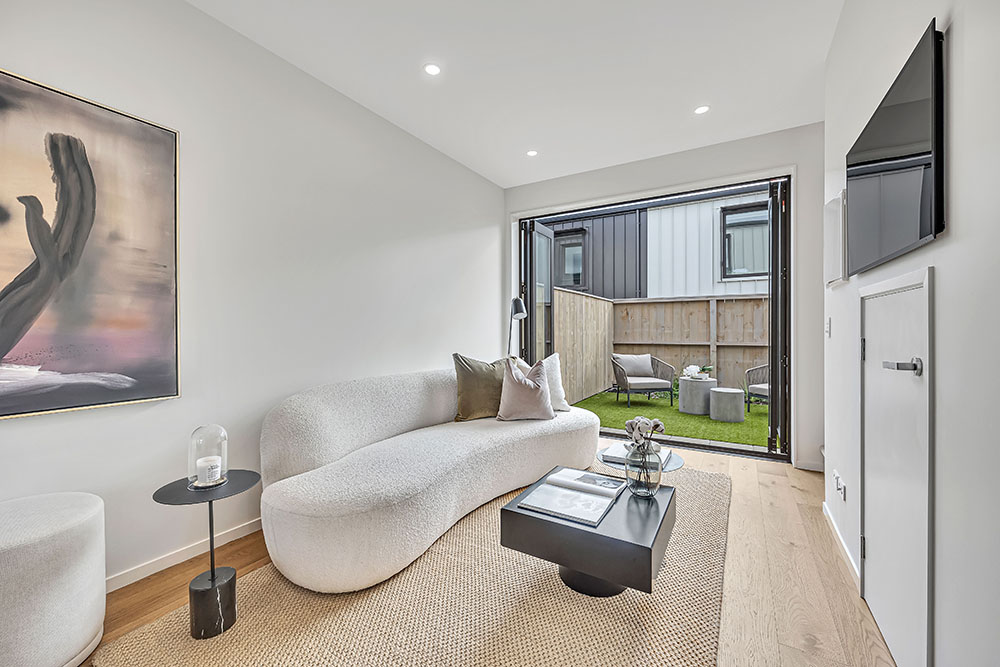 Inside a terraced housing unit built out of AFS logicwall IT walls, with outside doors open looking into the backyard